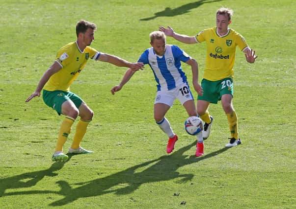 Huddersfield Town's Alex Pritchard (centre) battles with Norwich City's Christoph Zimmermann (left) and Oliver Skipp (Picture: Richard Sellers/PA)