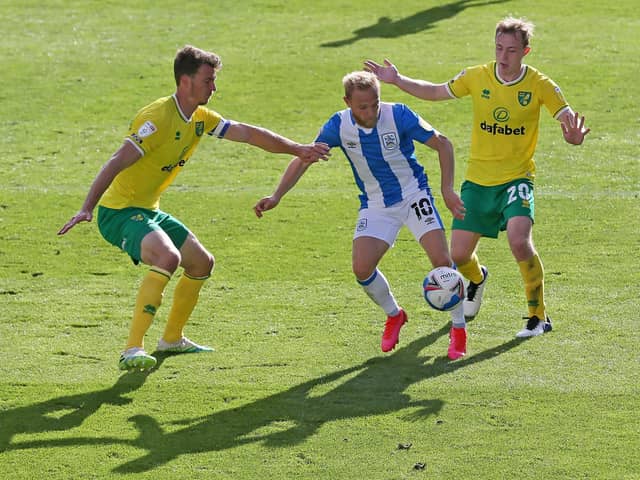 Huddersfield Town's Alex Pritchard (centre) battles with Norwich City's Christoph Zimmermann (left) and Oliver Skipp (Picture: Richard Sellers/PA)