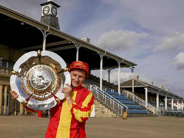 Tom Marquand with the Pertemps St Leger trophy after Galileo Chrone won the world's oldest Classic.