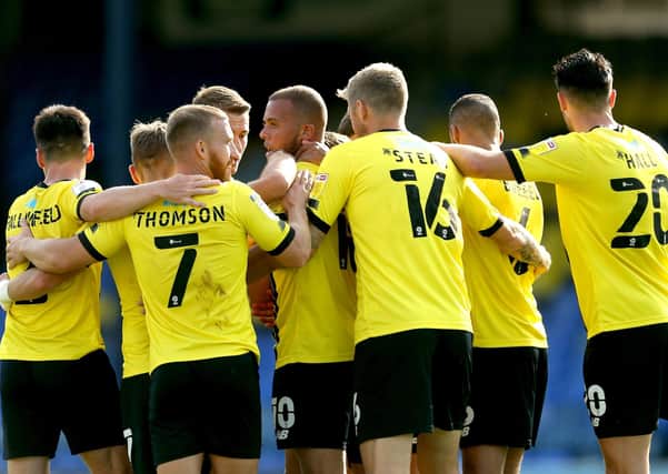 Harrogate Town's Aaron Martin (centre) celebrates scoring his side's third goal of the game with his teammates as Harrogate began life in the EFL with a thrashing of Southend United (Pictures: Steve Paston/PA)