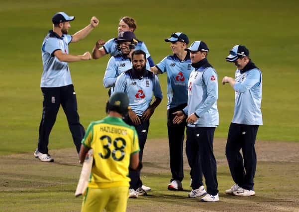 England's Jos Buttler (third left) and Adil Rashid (centre) celebrate with their team-mates after they combine to dismiss Australia's Alex Carey to win the second Royal London ODI match at Emirates Old Trafford.
