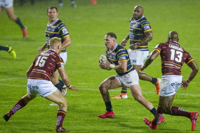 On the attack: Rhinos' James Donaldson runs at the Huddersfield defence. Picture Bruce Rollinson