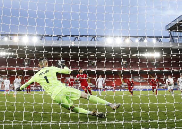 CRUEL BLOW: Liverpool's Mohamed Salah (centre) scores his side'swinning goal late on from the penalty spot, sending Leeds United goalkeeper Ilan Meslier the wrong way at Anfield. Picture: Phil Noble/NMC Pool/PA