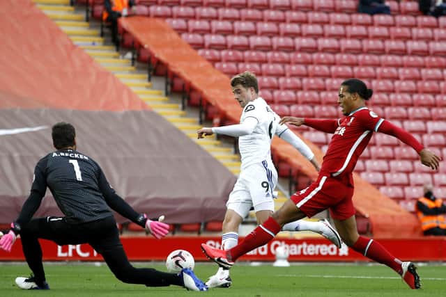 IN THE FIGHT: Leeds United's Patrick Bamford (centre) scores his side's second goal at Anfield. Picture: Phil Noble/NMC Pool/PA