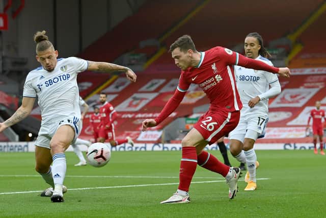 BACK IN THE BIG TIME: Leeds United's Kalvin Phillips (left) and Liverpool's Andrew Robertson in action at Anfield. Picture: Paul Ellis/NMC Pool/PA