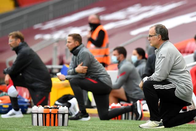Leeds United manager Marcelo Bielsa, right, and Liverpool counterpart Jurgen Klopp, far left, take a knee in support of the Black Lives Matter movement before their Premier League encounter at Anfield. Picture: Paul Ellis/NMC Pool/PA