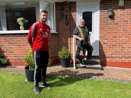 Pictured Josh Blunkett (SUCF Staff), left and Shaun Pearson as he receives a care package as part of the Sheffield United Community Foundation programme Fans Fighting Cancer. Photo credit: Maddy Cusack