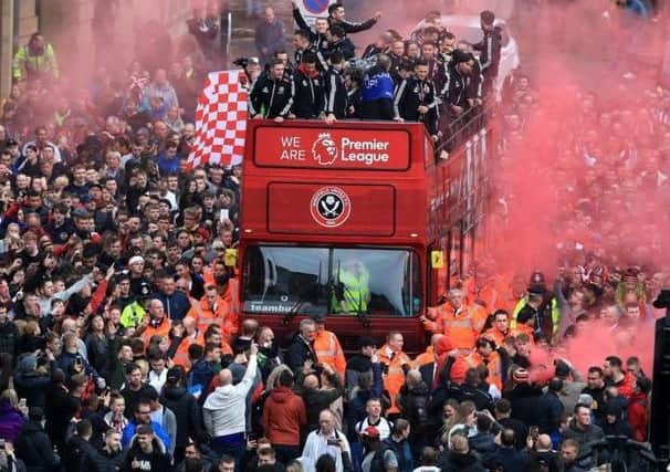 Pictured, the Sheffield United players and manager Chris Wilder wave to the fans during the promotion parade in Sheffield City centre in May 2019. Pic: Danny Lawson/PA Wire.
