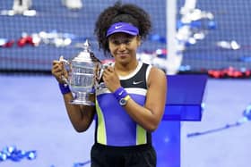 Naomi Osaka, of Japan, holds up the championship trophy after defeating Victoria Azarenka, of Belarus, in the women's singles final of the US Open tennis championships. (AP Photo/Frank Franklin II)