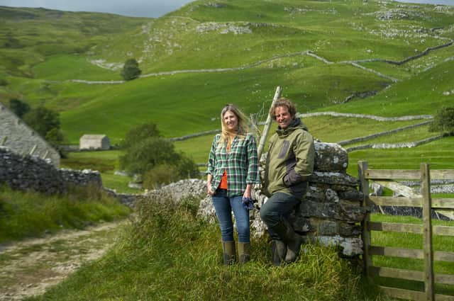 Farmers Leigh Weston and Neil Heseltine above Hill Top Farm in Malham. The couple have a bunkhouse and are among the tourism businesses in the Dales hoping to benefit from the new series of All Creatures Great and Small. Picture Tony Johnson