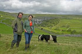 Farmers Leigh Weston and Neil Heseltine with their Belted Galloway cattle above Hill Top Farm in the shadow of Malham Cove. The couple have a bunkhouse and are among the tourism businesses in the Dales hoping to benefit from the new series of All Creatures Great and Small. Picture Tony Johnson