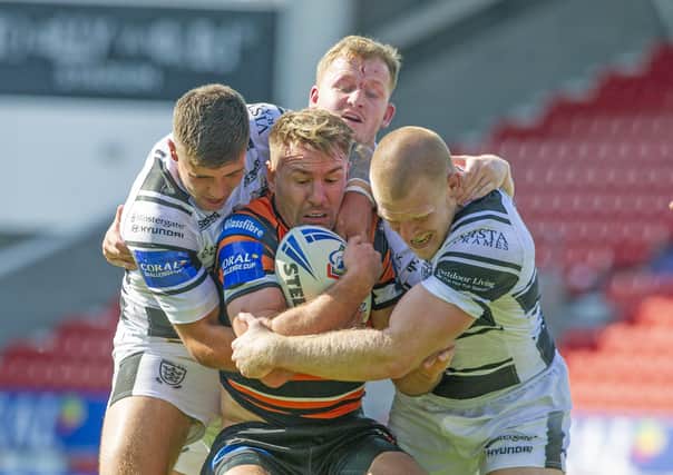 Castleford 
Tigers' Michael Shenton wrapped up by the Hull defence. (Picture: Tony Johnson)
