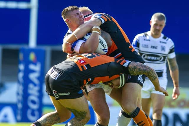 Impact - Hull's Joe Cator hit by Tigers' George Griffin and Oliver Holmes. (Picture: Tony Johnson)