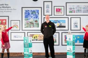 (Pictured from left) Barnby Dun Primary Academy pupils Evelyn Bowman, nine, and Martha Bowman, six, survey the school's artwork which pays tribute to key workers with Store Manager Neil Holmes at the launch of the Barnby Dun store.