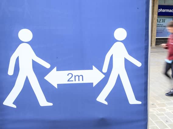 A social distancing sign in Leeds city centre, West Yorkshire. Photo: PA