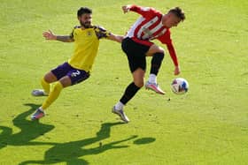 Brentford's Sergi Canos (right) and Huddersfield Town's Pipa battle for the ball.