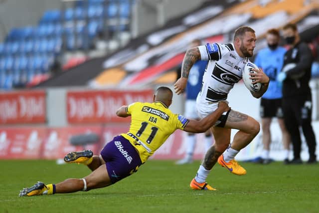 Striding out: Hull's Josh Griffin looks to get away from Wigan's Willie Isa in the Challenge Cup defeat. Picture: Jonathan Gawthorpe