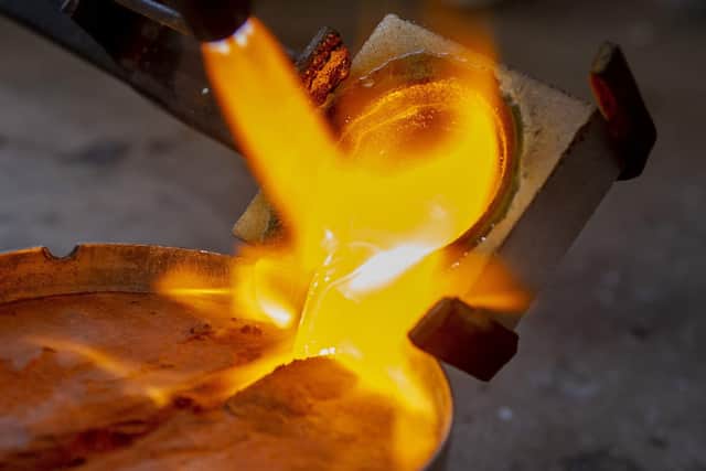 Mark Bell pours molten 18 carat gold into a mould in his Wetherby workshop.
 Picture Tony Johnson