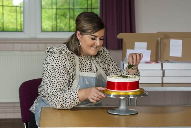 Recipe tester Nathalie Taylor decorating a Christmas cake at Appletreewick Village Hall.  Tony Johnson