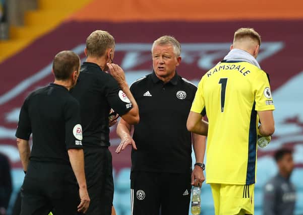 CONFUSED: Sheffield United boss Chris Wilder talks to referee Graham Scott at half-time at Villa Park. Picture: Clive Rose/Getty Images