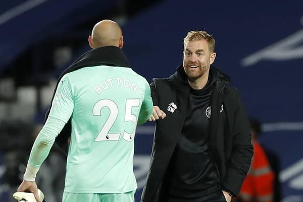Harrogate Town manager Simon Weaver, right, bumps fists with West Bromwich Albion goalkeeper David Button after the Carabao Cup second round clash last week. Picture: Andrew Couldridge/NMC Pool/PA