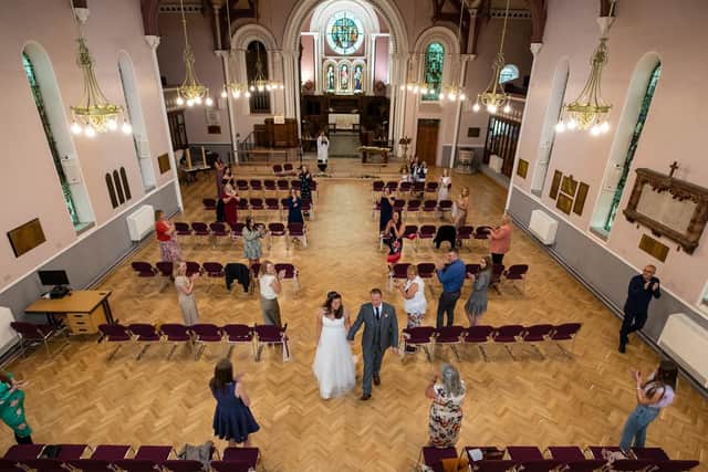 David D'Arcy and his wife Hayley Collins get married during their socially distanced wedding at St Anne's Church in Liverpool (PA Wire/Peter Byrne)