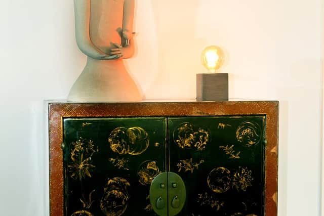 A treasured Korean cabinet, which is topped with a sculpture by York-based Chiu-I-Wu