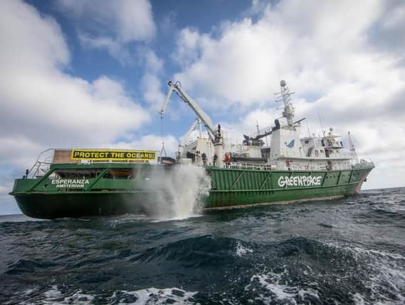 A boulder falls into the North Sea from the Greenpeace ship, Esperanza. Picture: Suzanne Plunkett/Greenpeace