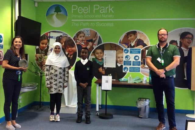 Pictured, left Harjyot Hayer, the History lead at Peel Park Primary School and Nursery, with the award and pupils from the school. Photo credit: Peel Park Primary School and Nursery.