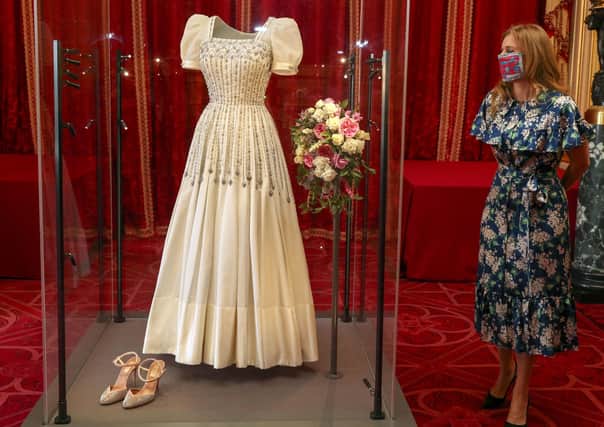 Princess Beatrice alongside her wedding dress, ahead of it going on public display at Windsor Castle from tomorrow. The Sir Norman Hartnell gown, first worn by the Queen in the 1960s, was loaned to Beatrice by her grandmother for her secret, low-key wedding to Edoardo Mapelli Mozzi in July. Picture: Steve Parsons/PA Wire