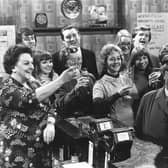 Some of the cast of the British television soap opera, 'Coronation Street' in the bar of the show's pub.   (Photo by Evening Standard/Getty Images)