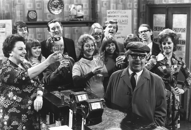 Some of the cast of the British television soap opera, 'Coronation Street' in the bar of the show's pub.   (Photo by Evening Standard/Getty Images)