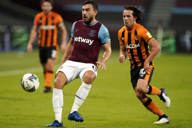 West Ham United's Robert Snodgrass (left) and Hull City's George Honeyman battle for the ball (Picture: PA)