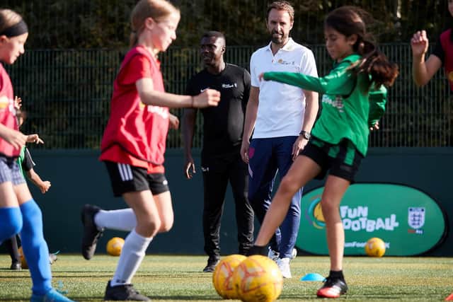 Gareth Southgate sees children developing their football skills. Photo: Mark Robinson/PA