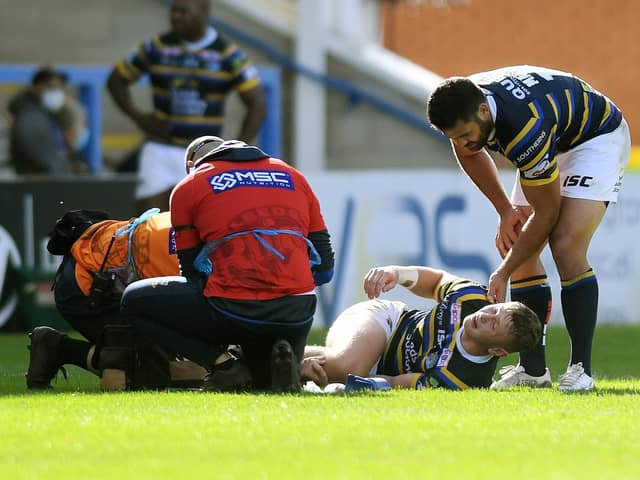 Big blow: Rhinos' Harry Newman is consoled by Rhyse Martin after his injury. Picture: Jonathan Gawthorpe
