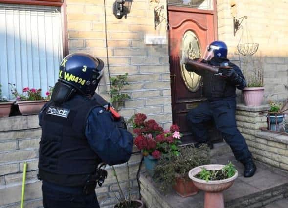 Picture issued by the National Police Chief's Council (NPCC) of a warrant being executed by an undisclosed police force as part of the county lines operation