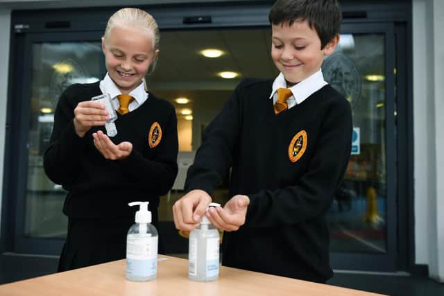 Richmond School pupils Lili Soley and Will Roberts pictured using the sanitising stations - one of the new safety measures implemented across the North Yorkshire school for the return of students. Photo credit: Jonathan Gawthorpe/ JPI Media Ltd Resell