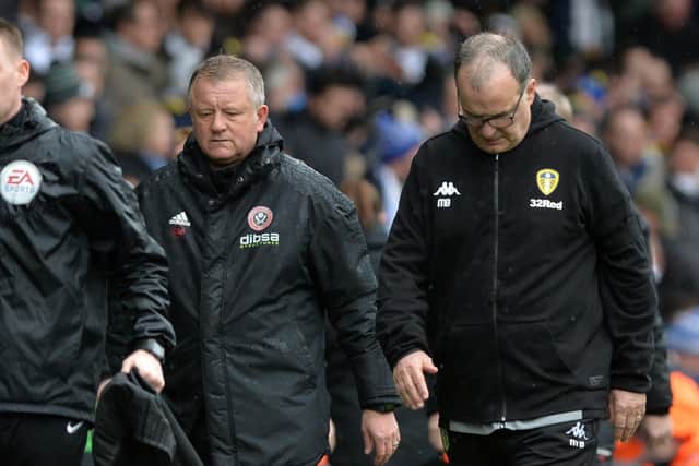 Chris Wilder and Marcelo Bielsa leave the pitch at half time of the Championship match between the two. (Picture: Bruce Rollinson)