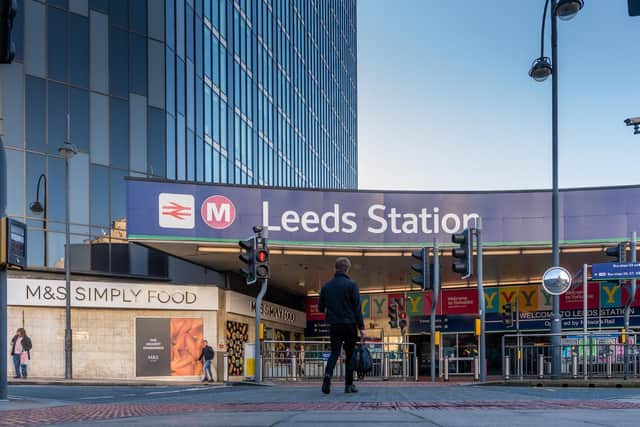 Two men who were stopped by police for smoking cannabis outside Leeds Station have been arrested after being found carrying knives.