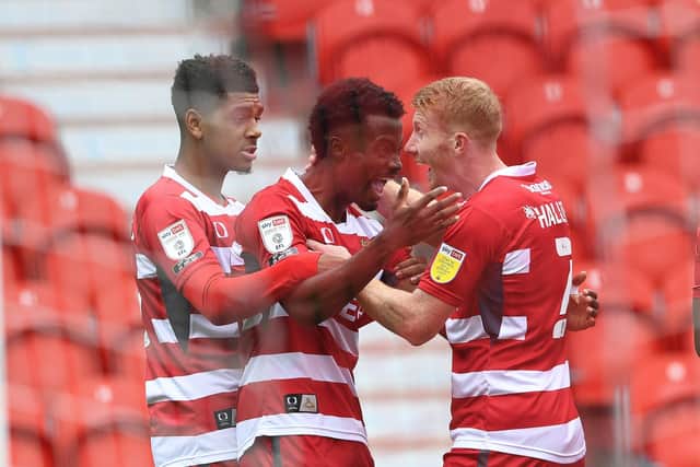Doncaster's Madger Gomes celebrates his goal with Brad Halliday and Tyreece John-Jules  (Picture: Howard Roe)