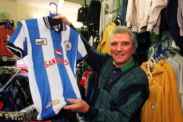 Shirts for sale: Former Sheffield Wednesday player John Quinn in his sports shop in Hillsborough.