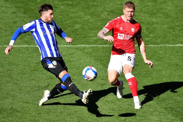 Sheffield Wednesday's Josh Windass (left) and Bristol City's Alfie Mawson battle for the ball (Picture: PA)