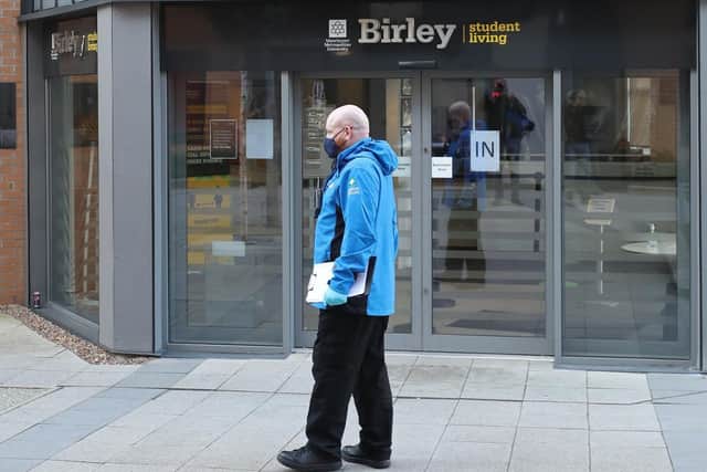 A man wearing a facemask at Manchester Metropolitan University's Birley campus where hundreds of students have been told to self-isolate