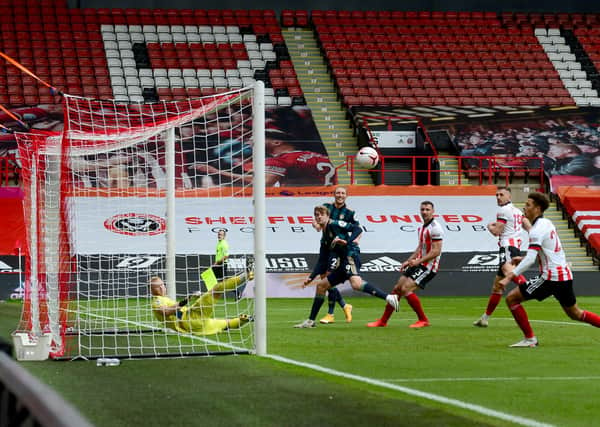 Heads you win: Patrick Bamford, left centre, steers the ball beyond the reach of Sheffield United goalkeeper Aaron Ramsdale to give Leeds United victory in an all-too rare Premier League derby between Yorkshire sides. (Picture: James Hardisty)