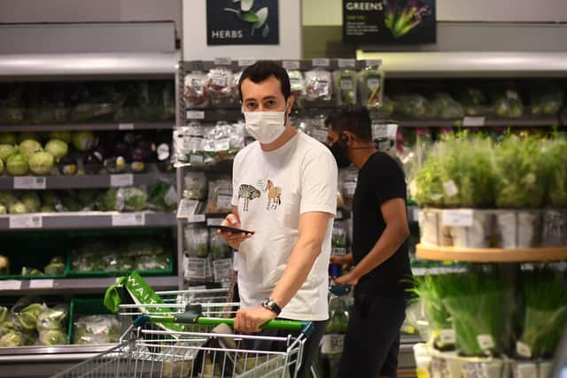 A shopper wearing a face mask in a supermarket in East London as face coverings become mandatory in shops and supermarkets in England. Picture: Victoria Jones/PA Wire