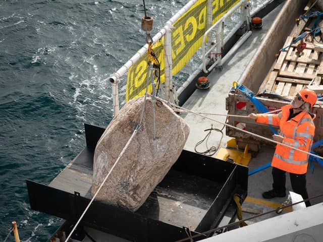 A boulder is manoeuvred onto a slide on the Greenpeace ship, Esperanza. Picture: Suzanne Plunkett/Greenpeace