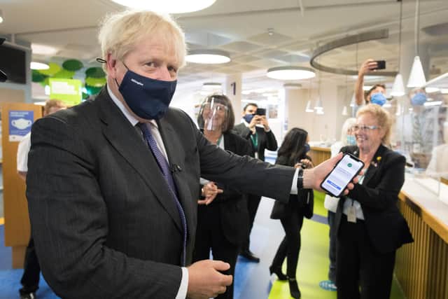 Boris Johnson shows off the NHS App.