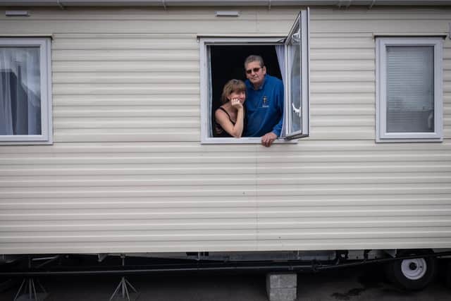 Glyn Davies and Jo Davies in their caravan. Flood victims forced to flee their homes in last year's "biblical" deluge face indefinite isolation in caravans after the coronavirus lockdown put on a halt on repair works. Photo: SWNS