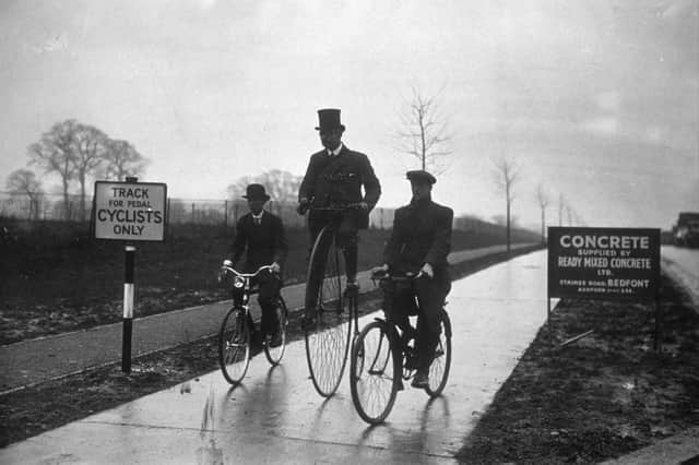 circa 1932:  Three men on various styles of bicycle, including a Penny Farthing (centre), riding down the newly opened Belisha cycling path between Hanger Lane and Greenford, Middlesex.  (Photo by Topical Press Agency/Getty Images)