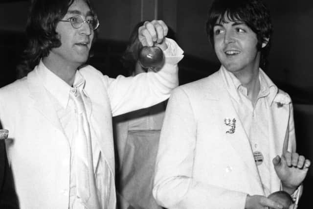 John Lennon and Paul McCartney at London Airport after a trip to America to promote their new company Apple Corps in 1968. (Getty Images).